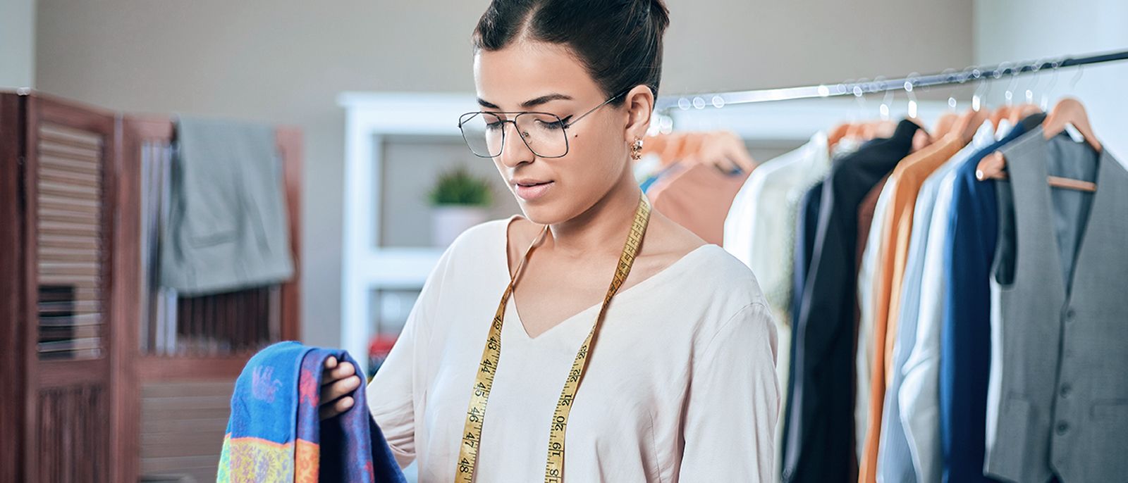 A seamstress folds fabrics