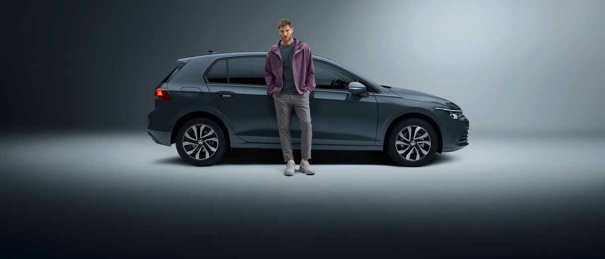 A man stands in front of his 1-month rental car