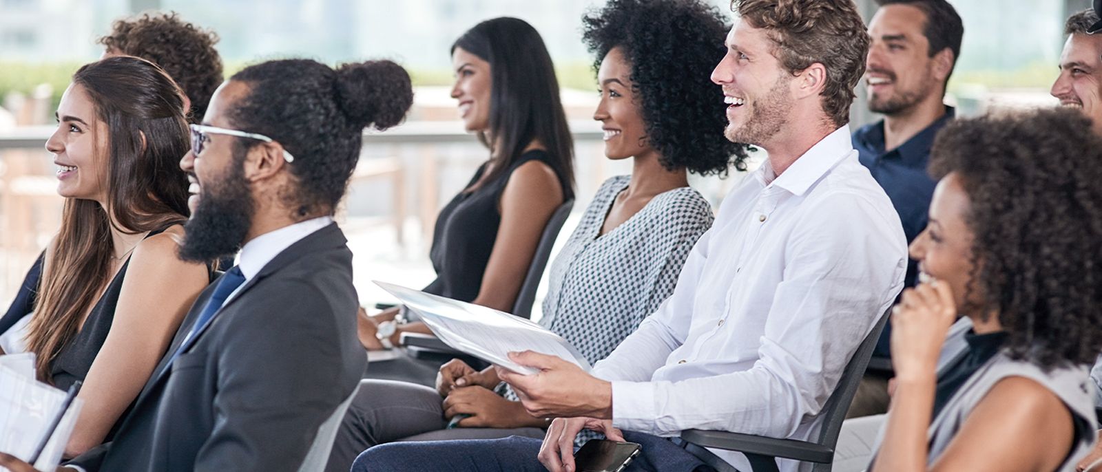 Several employees at a company meeting